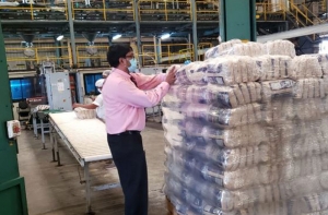 FLASHBACK- GuySuCo’s Chief Executive Officer, Sasenarine Singh, assisting in packing the first batch of packaged sugar at the Enmore Packaging Plant